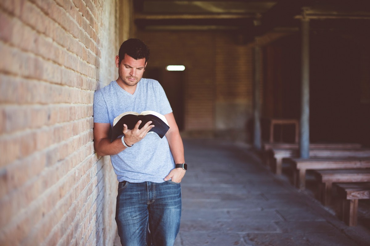 Giving Tuesday: reading a Bible in a church hallway